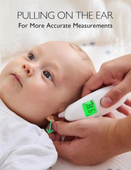 Momcozy FC-IR300 infrared thermometer in ear mode being used on a baby, demonstrating the clinical technique of gently pulling the earlobe back to straighten the ear canal for more accurate temperature readings at CHS Pharmacy UAE.