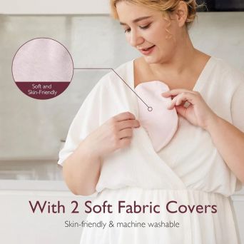 A breastfeeding mother demonstrates using the Momcozy Hot and Cold Breast Pads with the included soft fabric covers. She inserts the pink therapy pack into the skin-friendly, machine-washable cover before placing it inside her nursing bra for comfortable 