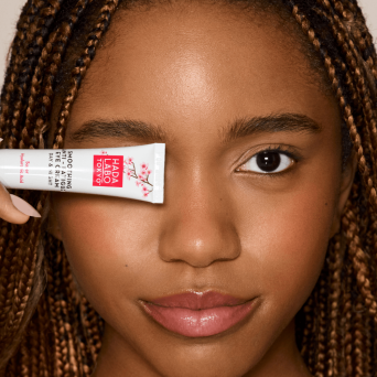 Woman applying Hada Labo hyaluronic acid eye cream around eye area, Japanese skincare for tired eyes