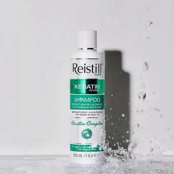 Reistill Keratin Infusion Shampoo for fine damaged hair bottle with water splash, keratin and argan oil strengthening formula