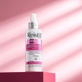 Reistill Colour Leave-In Spray Conditioner for coloured and damaged hair – bottle on pink background for shine and colour protection